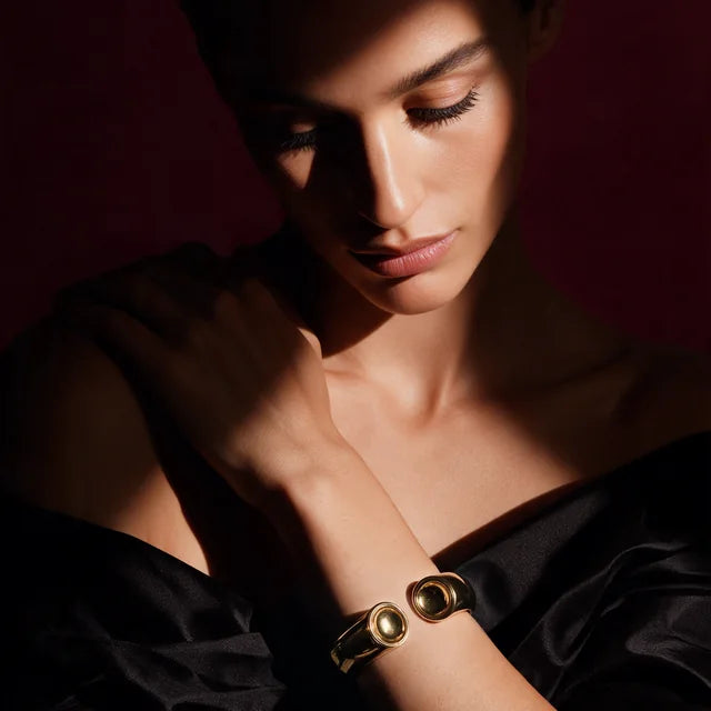 A model wearing the Patera Cuff in gold