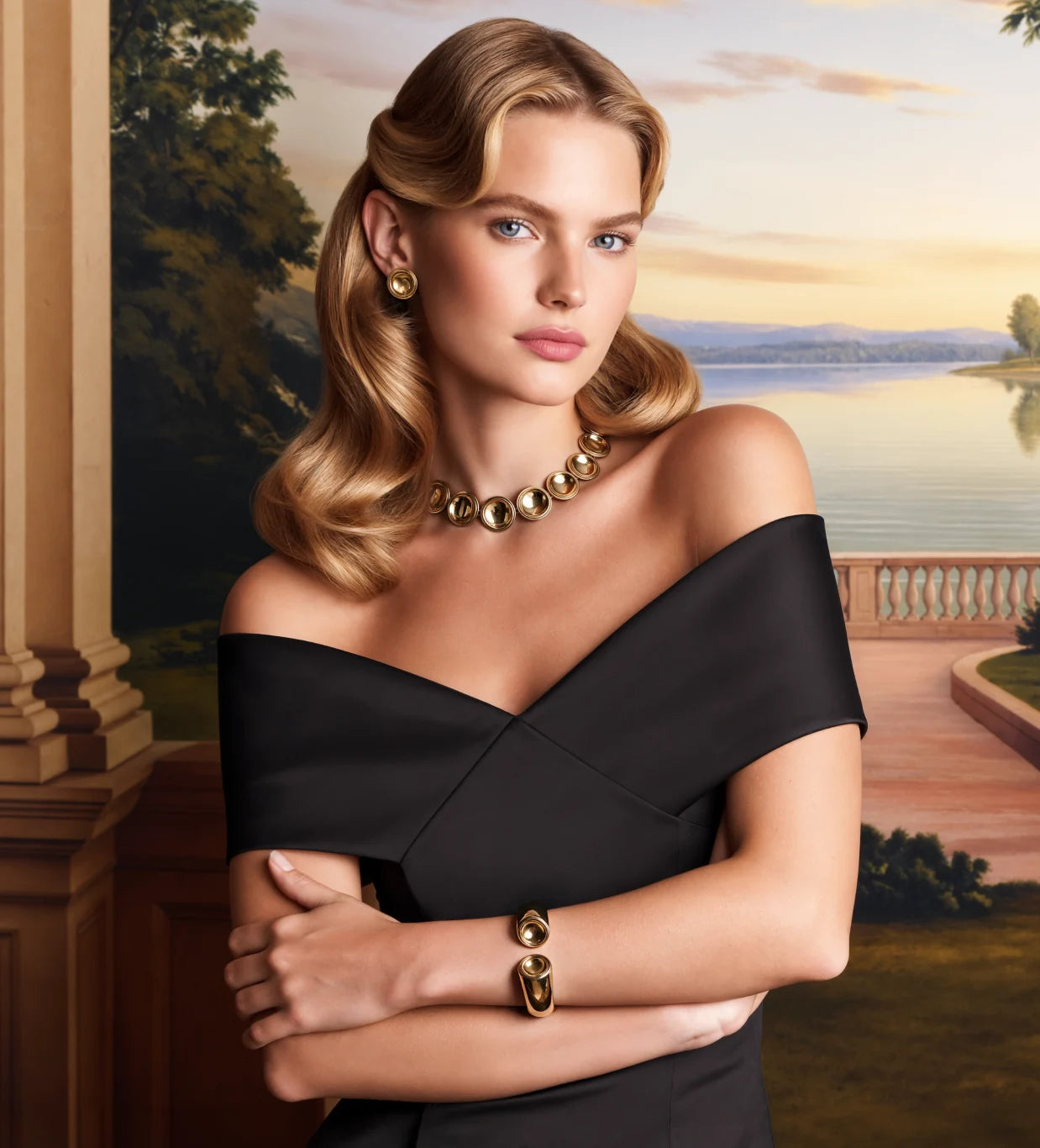 A model in a black dress wearing the Patera Necklace, Earrings and Cuff before a painted lake at sunset